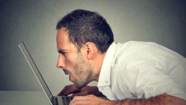 stock-photo-side-profile-young-man-with-vision-problems-using-computer-reading-email-browsing-internet-526367467